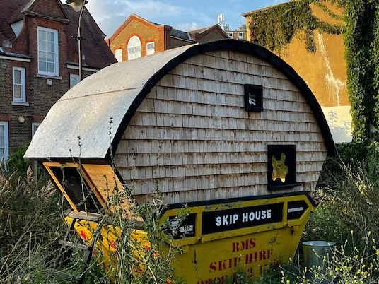Our reporter-in-the-field Mat Amp snapped a picture of the infamous ‘skip house’ in Bermondsey, London, a renovated skip designed and lived in by an artist protesting the cost of living crisis © Mat Amp