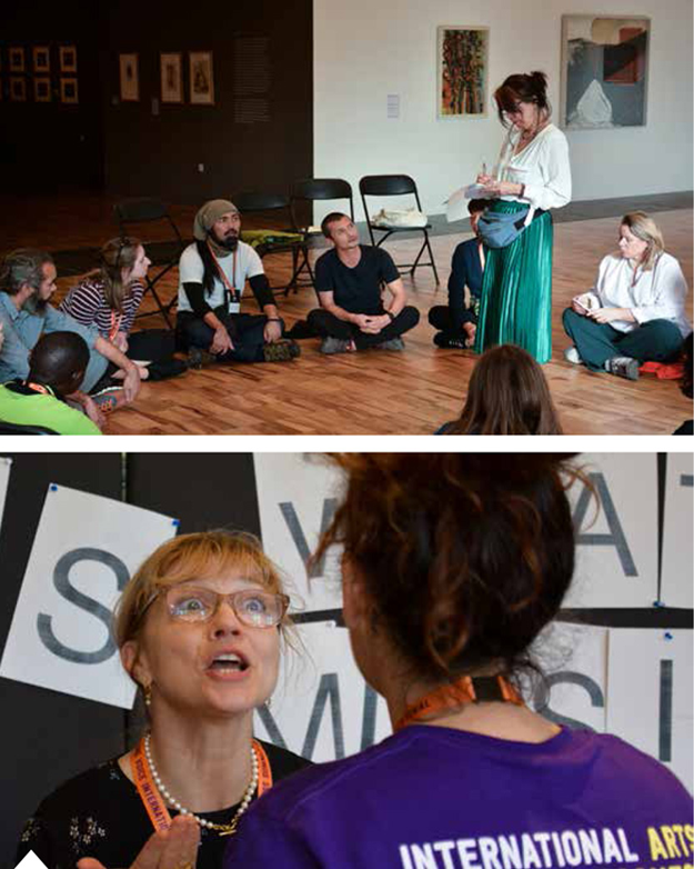 Top: Dance workshop at the 2018 International Arts & Homelessness Summit Bottom: Delegate speaking to event organiser Lora at the pledge wall. The Pavement pledged to spread the Summit's positive messages to our readers. © Marco Biagini & Jamie Jackson